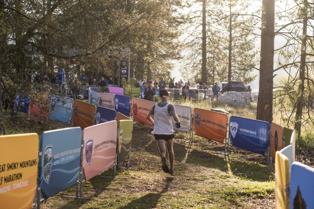 runner heading to the finish line in a pine forest in Yosemite
