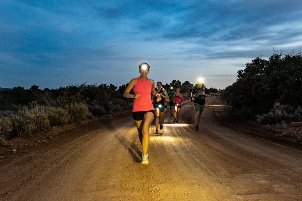 group running at dusk with headlamps