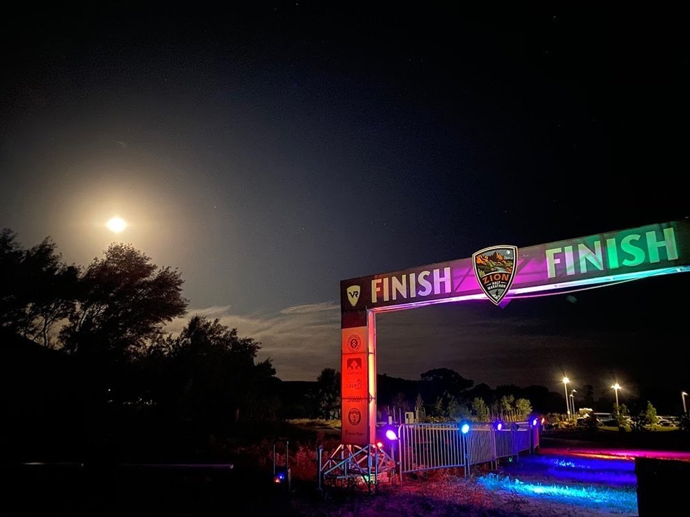 finish line arch lit up with colored lights