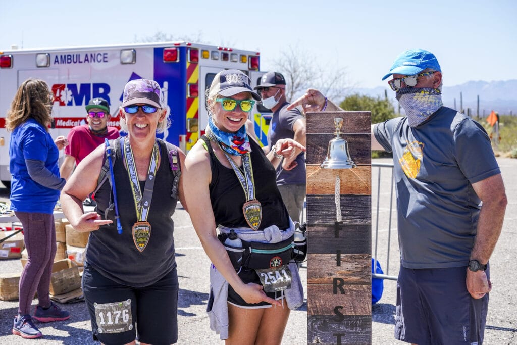 three runners posing with their medals and the 