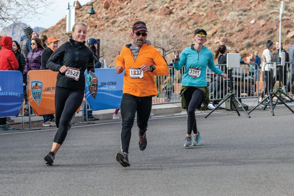 Three runners approaching the finish line