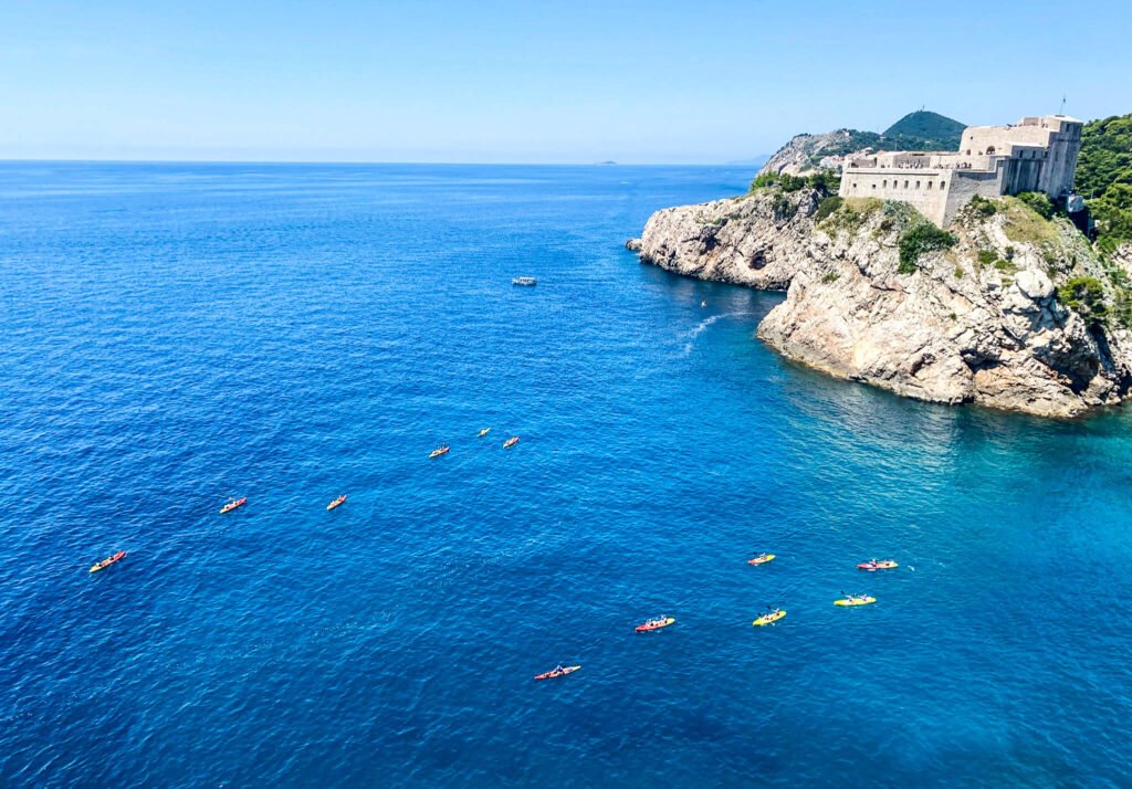 White cliffs on the mediterranean sea with boats in the water