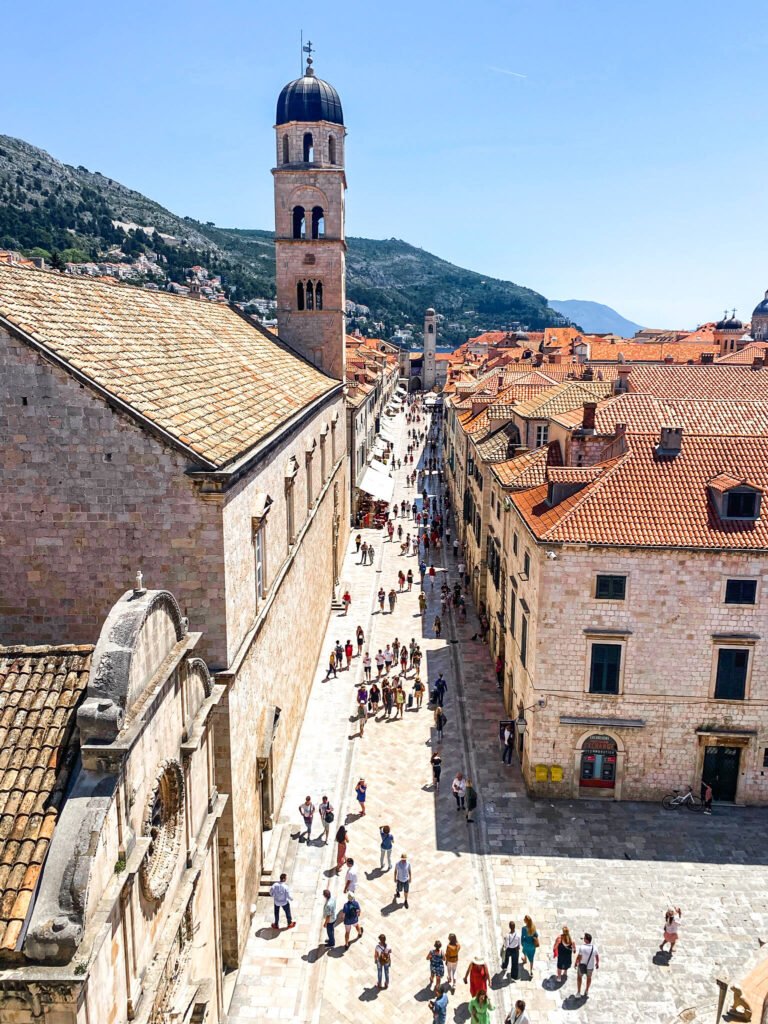 An aerial view into a town square with a bell tower