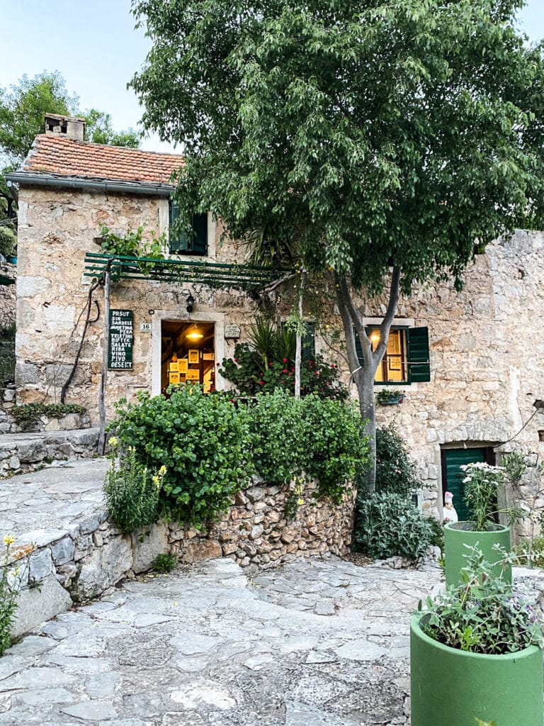 An ancient stone building with light coming out of the windows