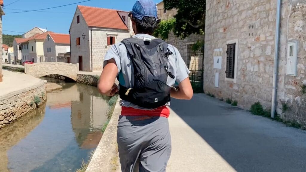 Back of a man running along a canal in Croatia
