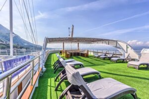 The top outdoor deck of the yacht with seating