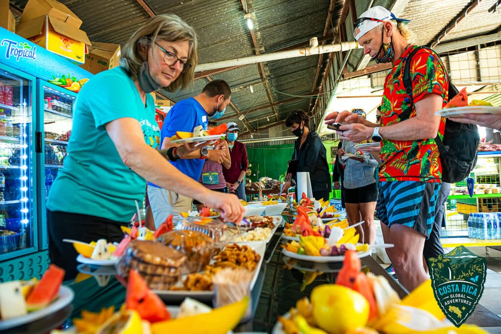 Runners filling their plates with tropical fruit