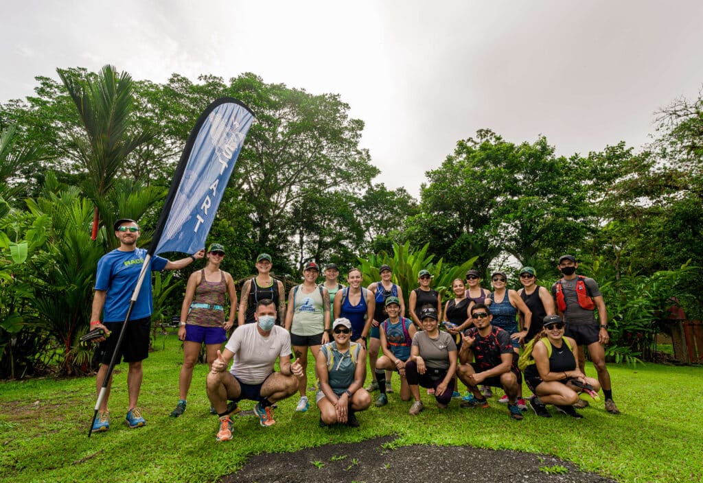 Group of staff and runners posing at the start line