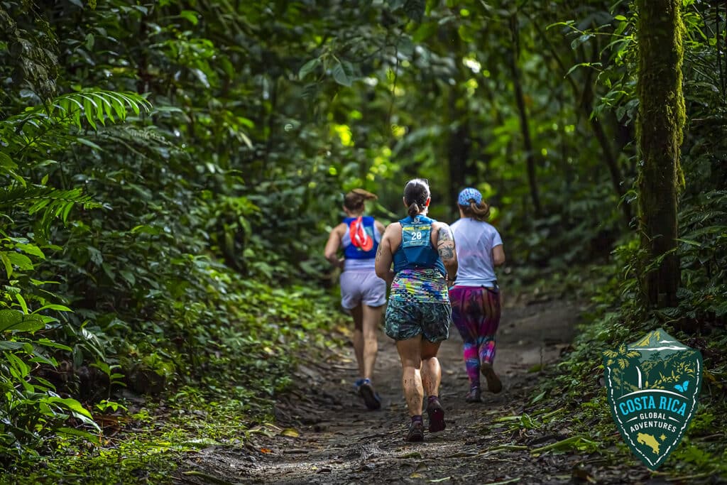 A group running through a shady, lush trail