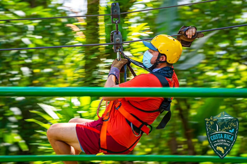 A person in red zipping through the trees