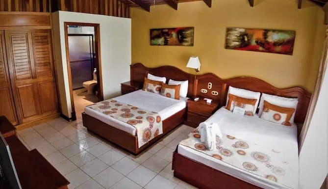 Sunny high ceiling hotel room at Arenal Paraiso