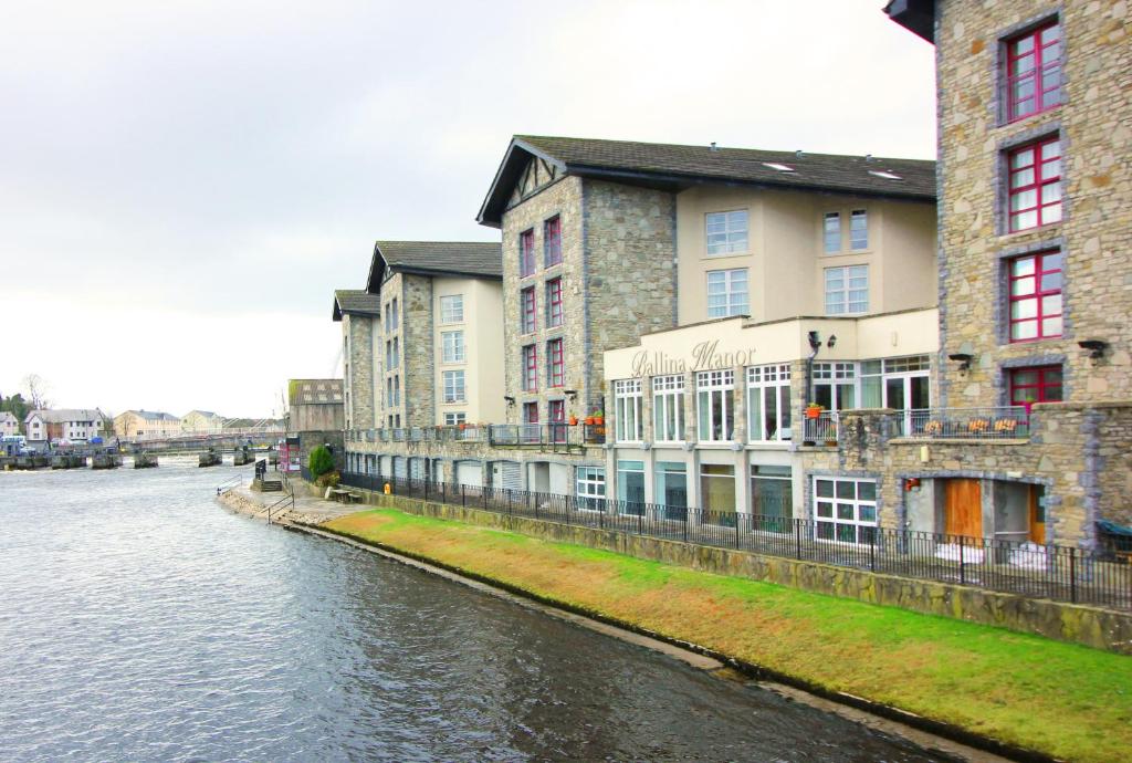 The stone exterior of the Ballina Manor Hotel overlooking a waterway