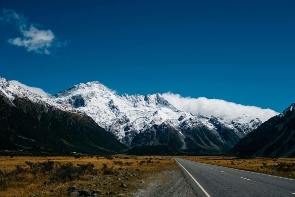 Mount Cook rises above a wide valley in New Zealand