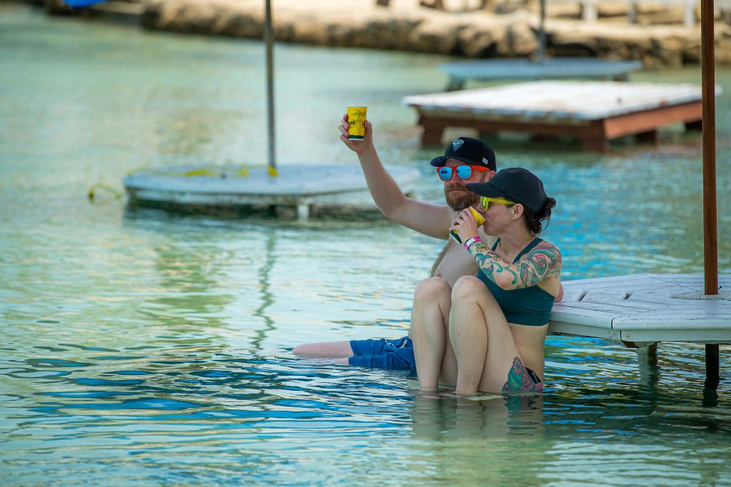 A couple cheers in the tropical waters of Belize