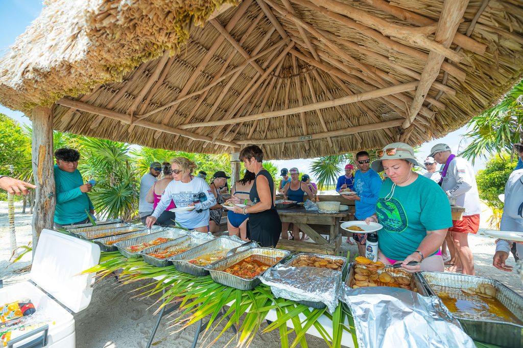 Runners enjoy a Caribbean feast at the beach after a trail run on their Global Adventures Belize runners pose at the start line of their all-inclusive running trip