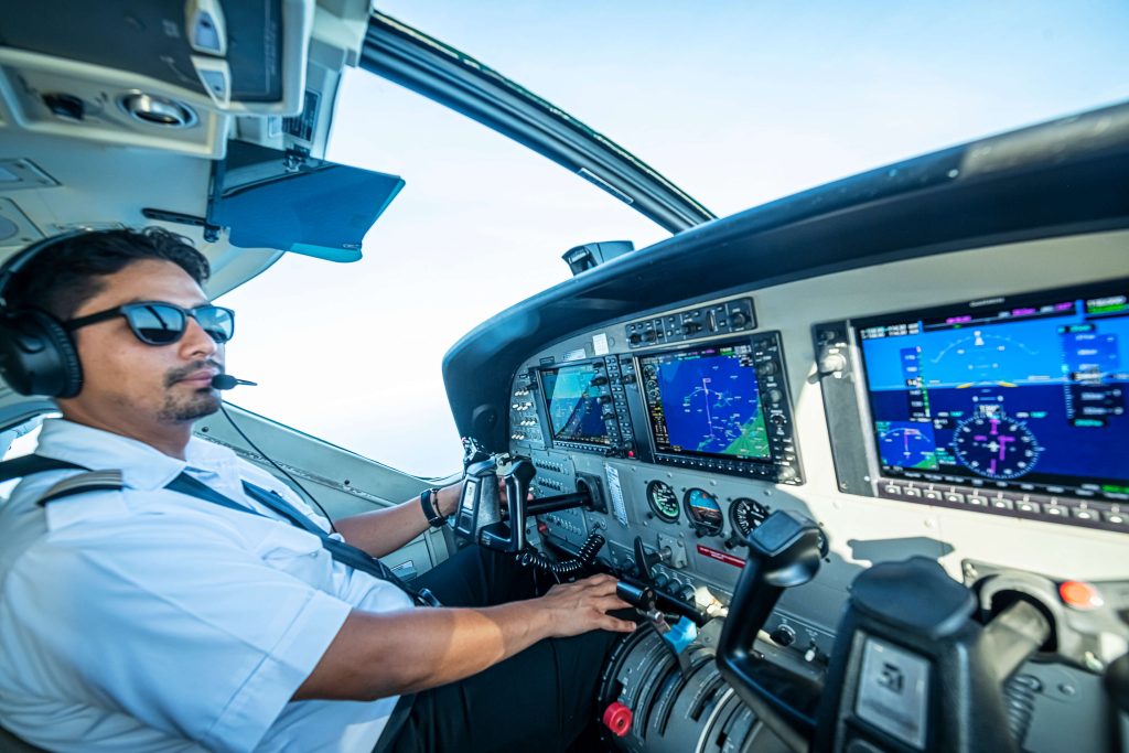 A pilot flies runners over Blue Hole in Belize