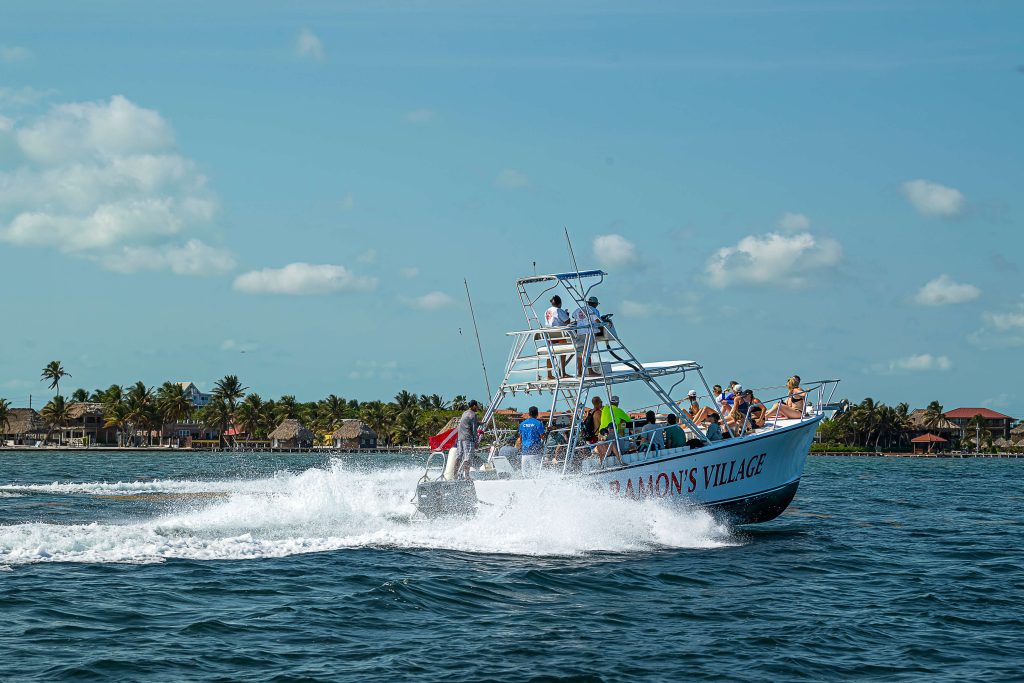A speed boat carries runners across blue tropical waters