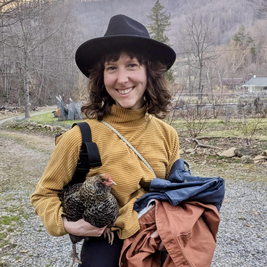 Lyssa our Customer Experience Manager holding two chickens