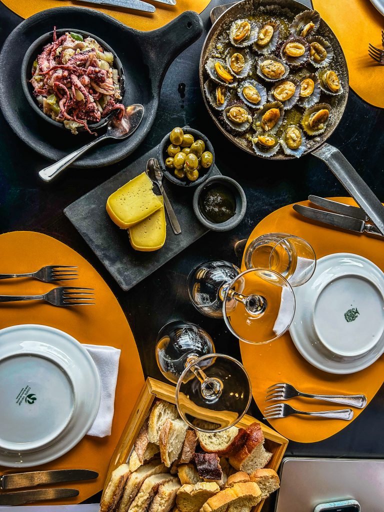 A table of Portuguese seafood, olives, and local delights are enjoyed by Vacation Races runners