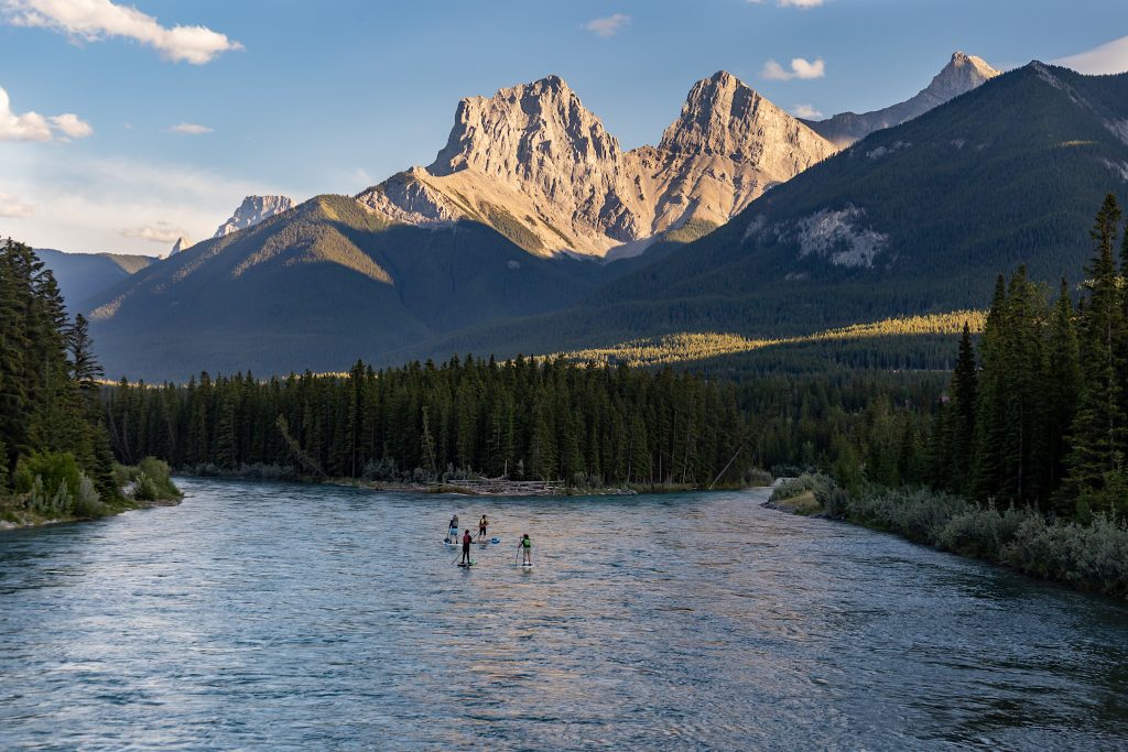 Bow River and forests in the shadow of Three Sisters Mountain in Canmore, Alberta Canada