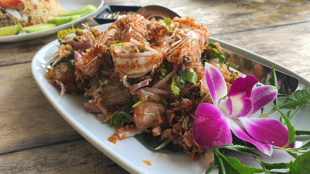 Thai shrimp are plated with tropical flowers